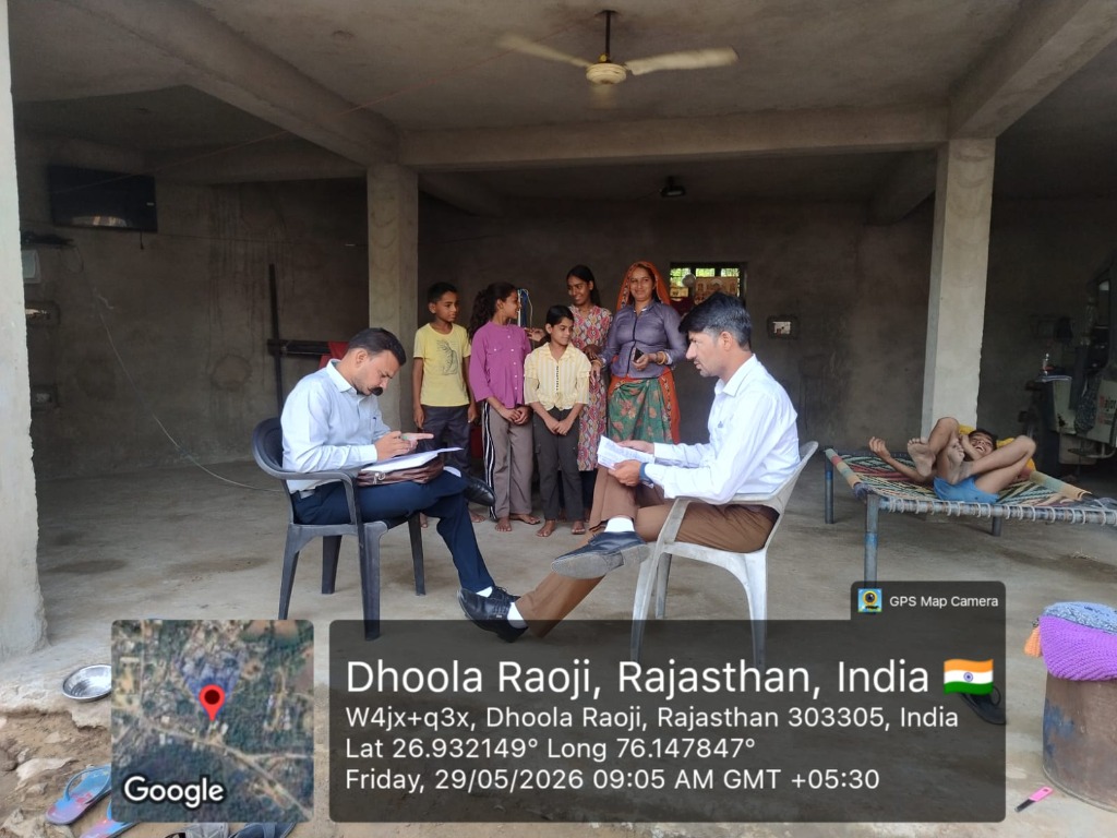 NGO worker conducting a student enrollment survey in Dhoola Raoji village, Rajasthan