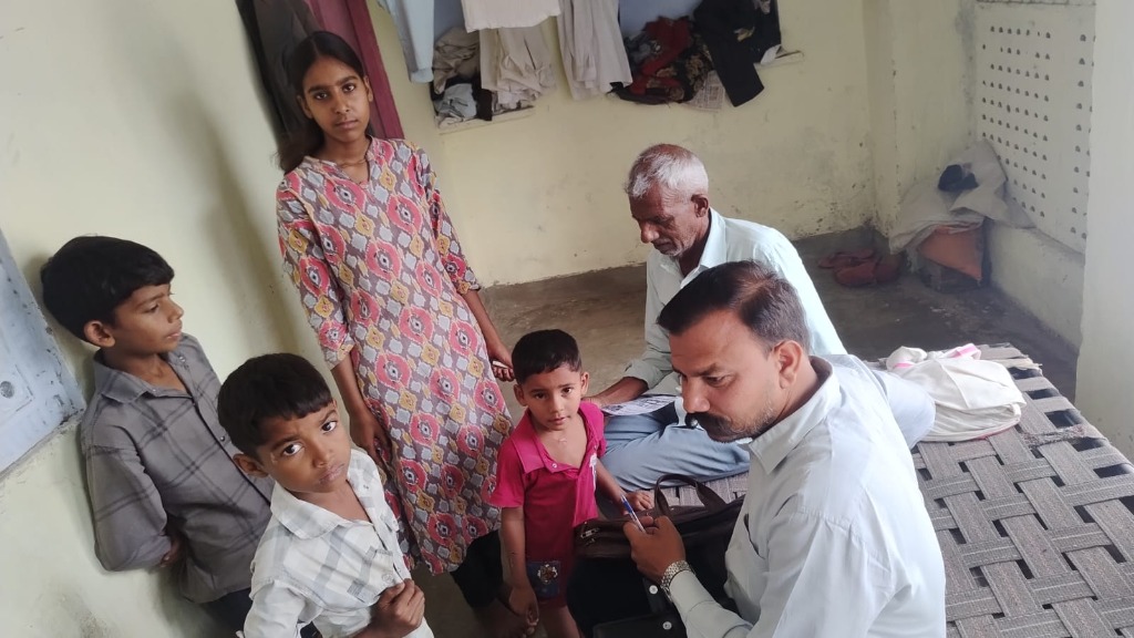 NGO worker conducting home surveys and checking child education needs