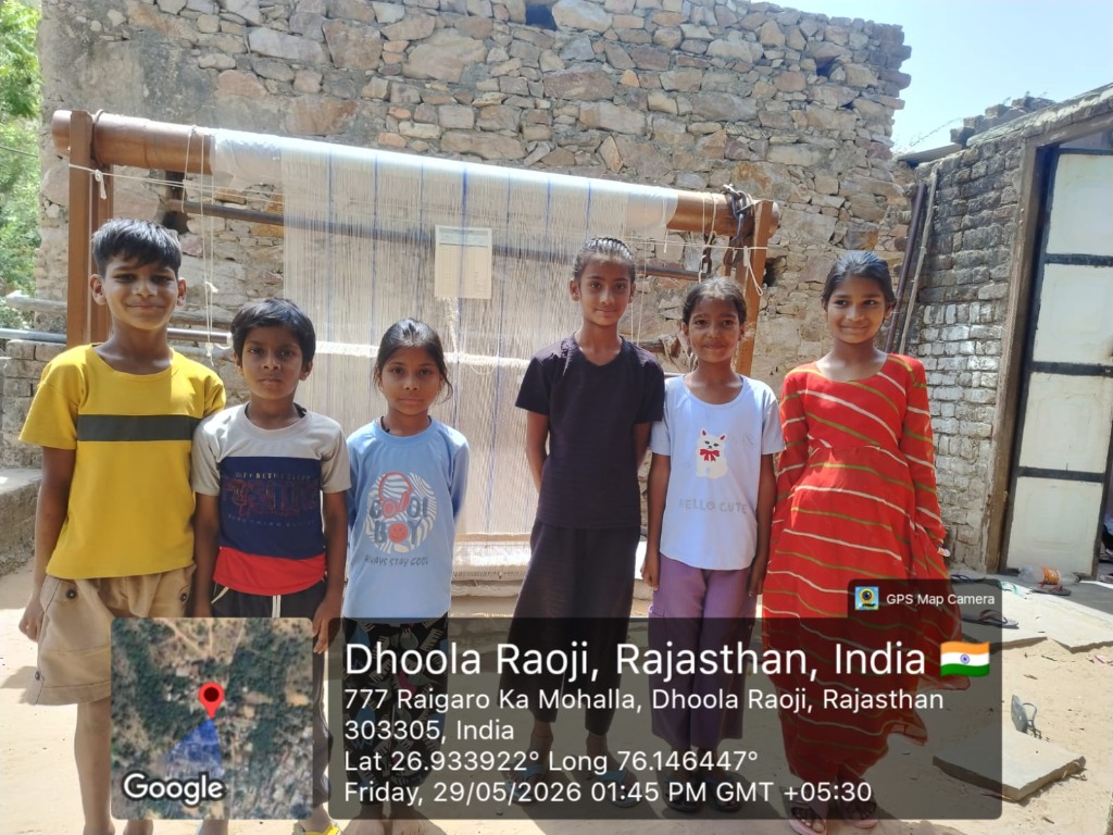 Group of children participating in community welfare outreach in Dhoola Raoji village